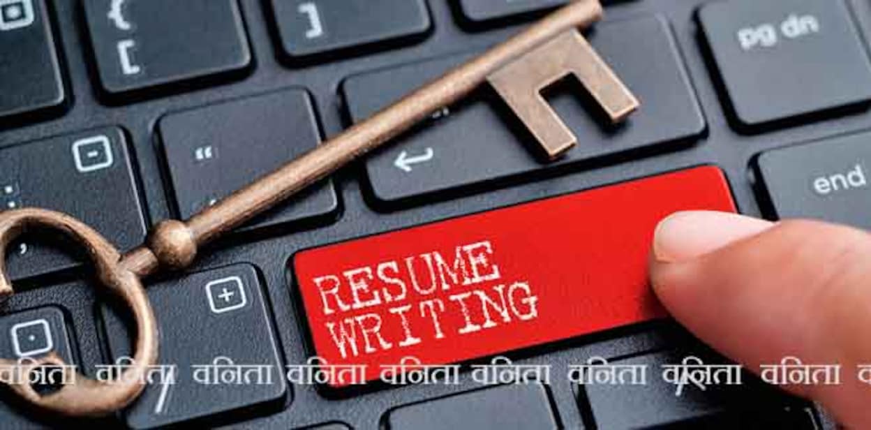 Closed up finger on keyboard with word RESUME WRITING