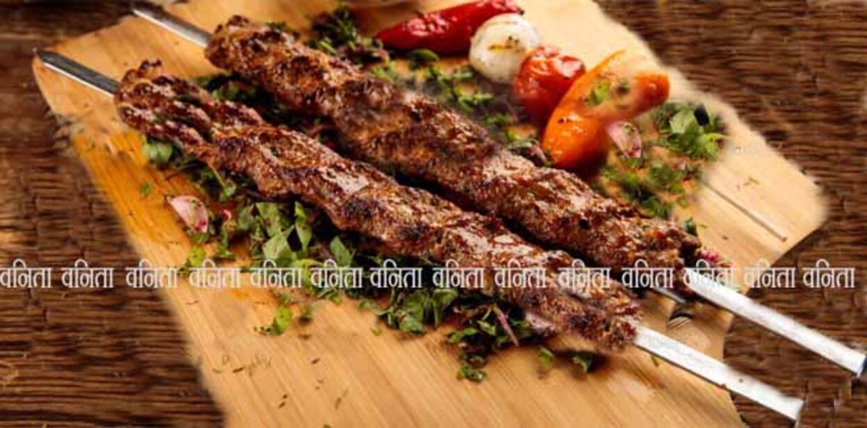 seekh-kebab Adana Kebab served in a wooden cutting board isolated on wooden background side view