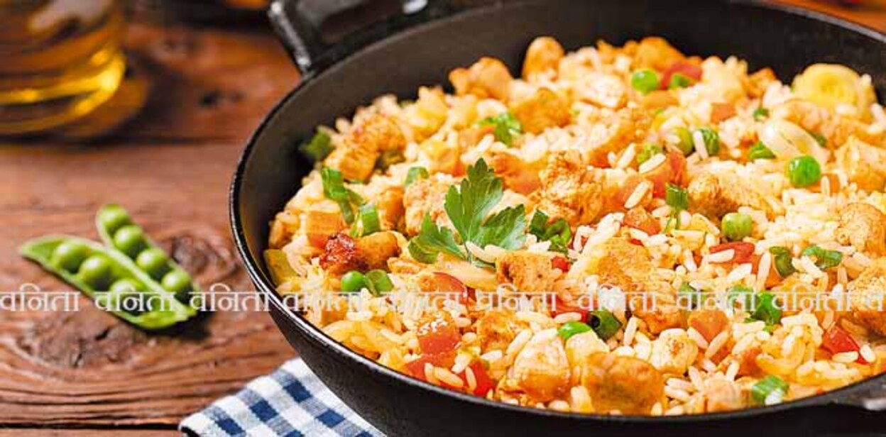 677985067 Fried rice with chicken. Prepared and served in a wok. Natural wood in the background. Front view.