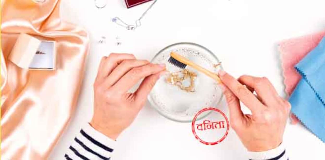 jewellery Woman hands cleaning and polishing jewelry necklace with homemade jewelry cleaner at home. Top view