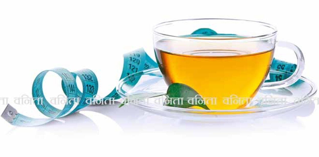 Weight loss concept. Cup of tea and measuring tape isolated on white
