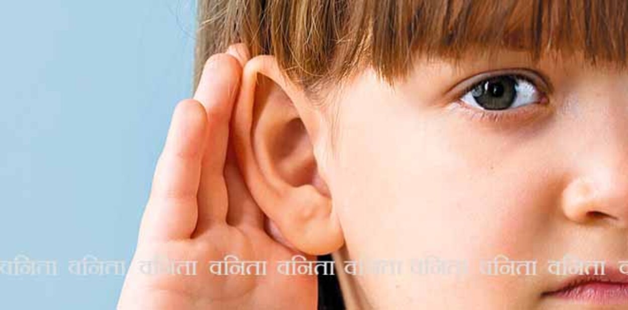 Child with hearing problem on blue background. Hearing loss, symptoms and treatment concept. Close up, copy space.