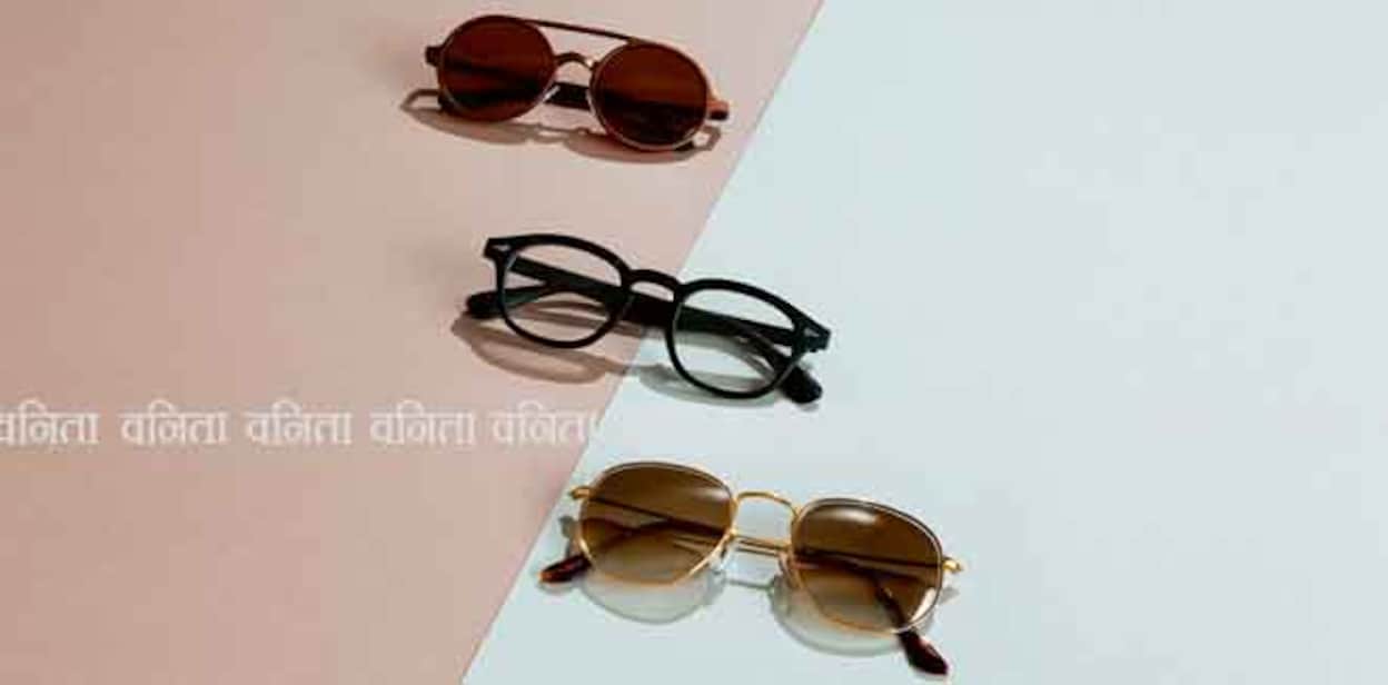Three pairs of male classic sunglasses and eye glasses on abstract gray and brown paper background. Men eyewear fashion concept.