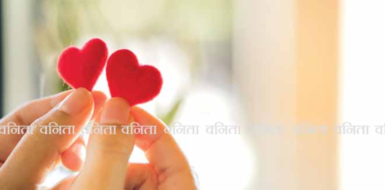 Female hands holding a couple red heart, selective focus 