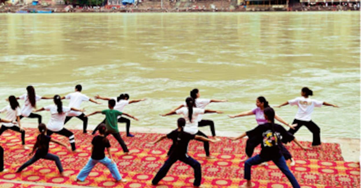 People Practicing Yoga on the Banks of Ganga River During International Yoga Day in Rishikesh, India. 29th June 2025