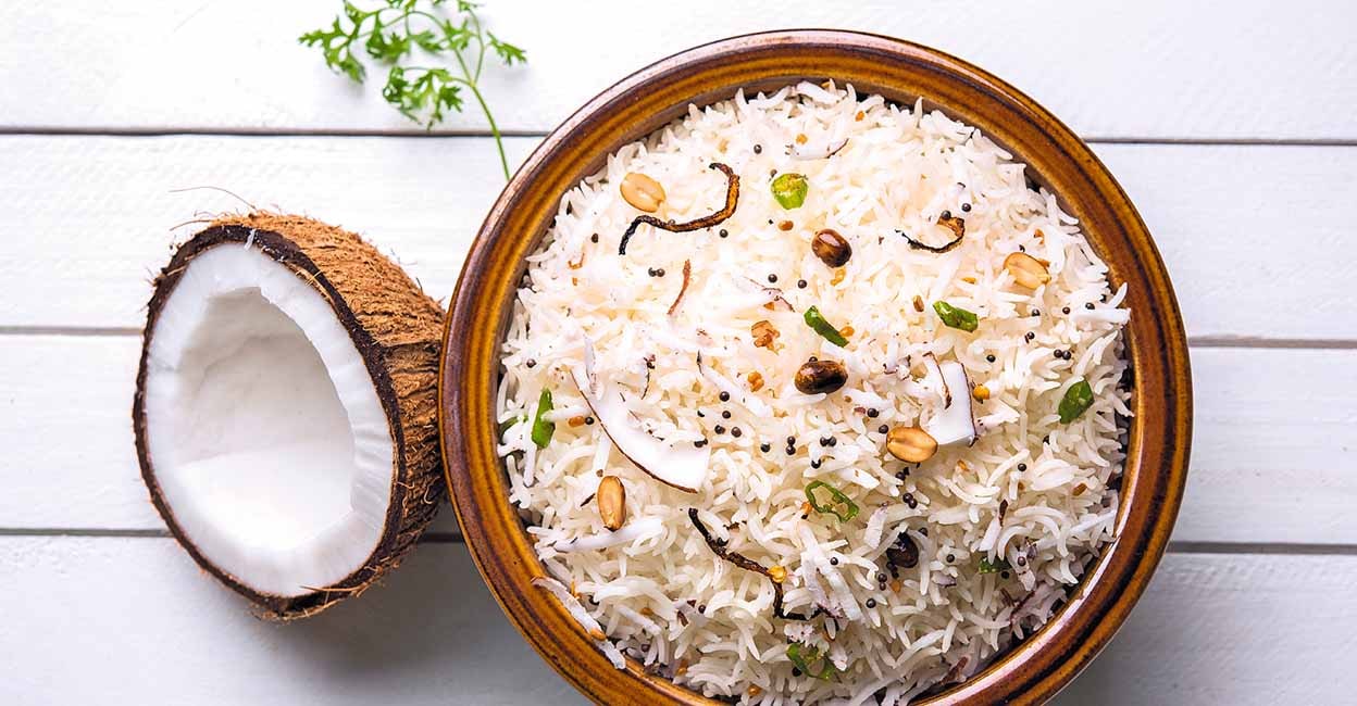 Coconut Rice is a popular South Indian food, served in a bowl over moody background. selective focus