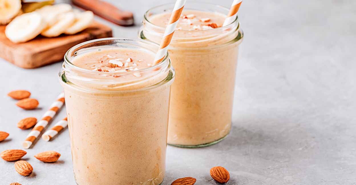 Healthy breakfast. Banana almond smoothie with cinnamon and oat flakes and coconut milk in glass jars