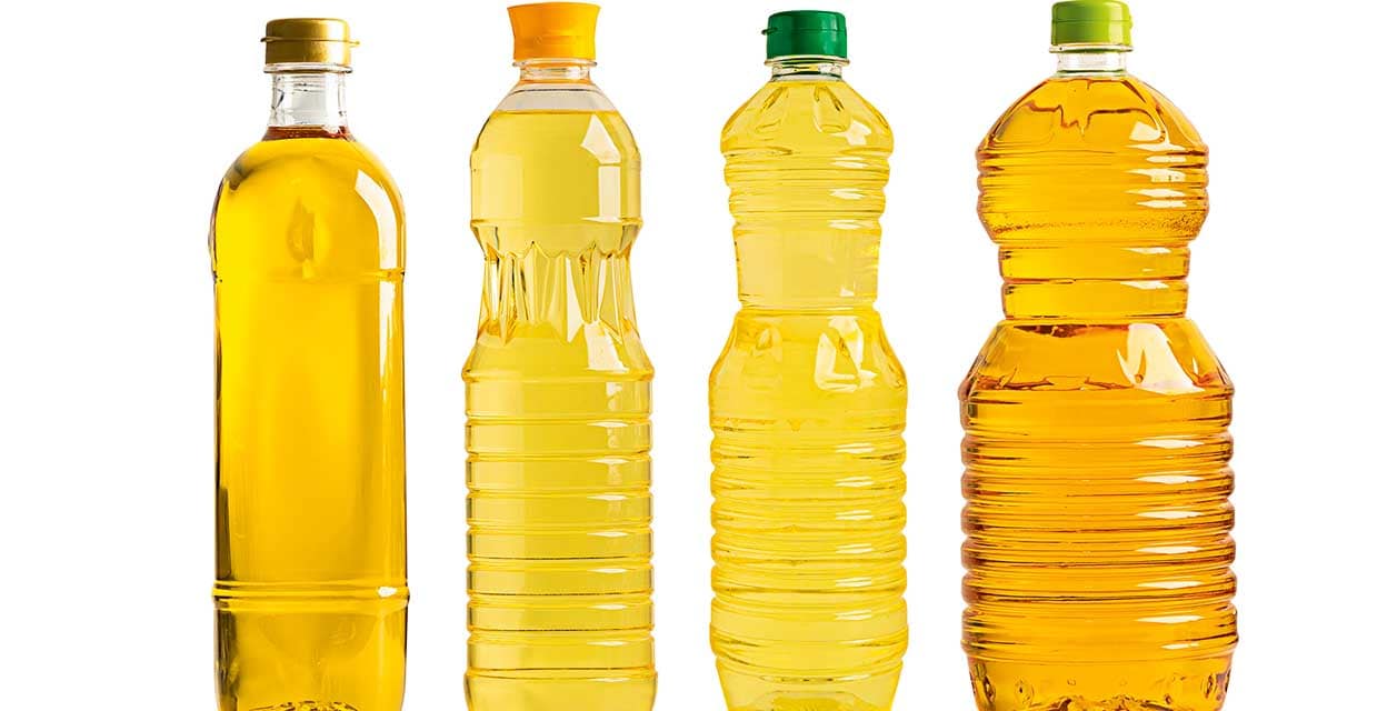 Vegetable oil with olive oil in different bottle for cooking isolated on white background with clipping path.