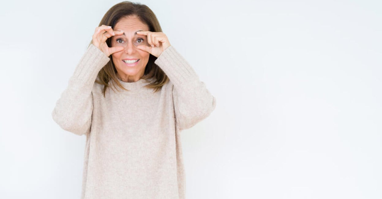 Beautiful middle age woman over isolated background Trying to open eyes with fingers, sleepy and tired for morning fatigue