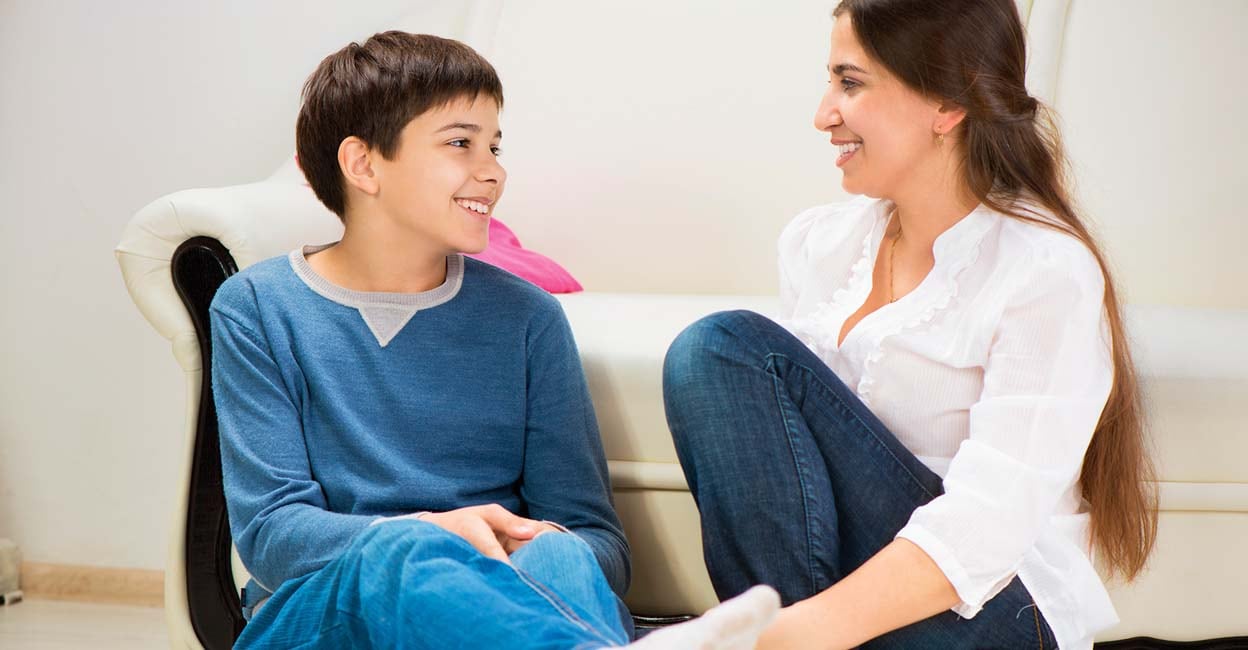 Cute teen boy with his young mother at home