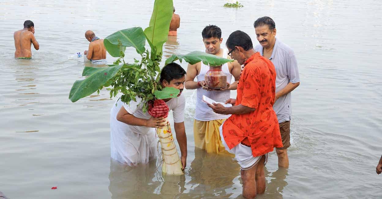 Kolkata,West Bengal,INDIA- October 10, 2024. Bathing of Banana tree at the River Ganges, as rituals,on the first day of four day long Durga Puja, a Hindu festival.