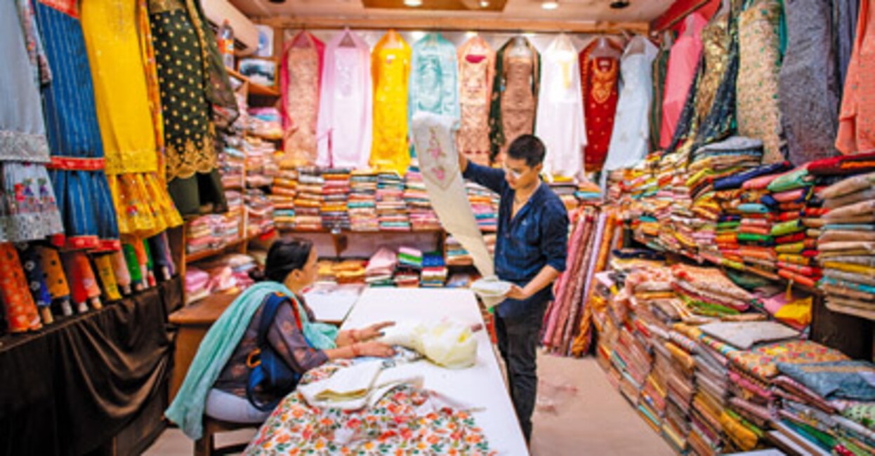 Lucknow, Uttar Pradesh, India-28 June 2023: woman buying clothes at Aminabad market, one of busiest and oldest shopping districts, renowned marketplace in Old Lucknow.